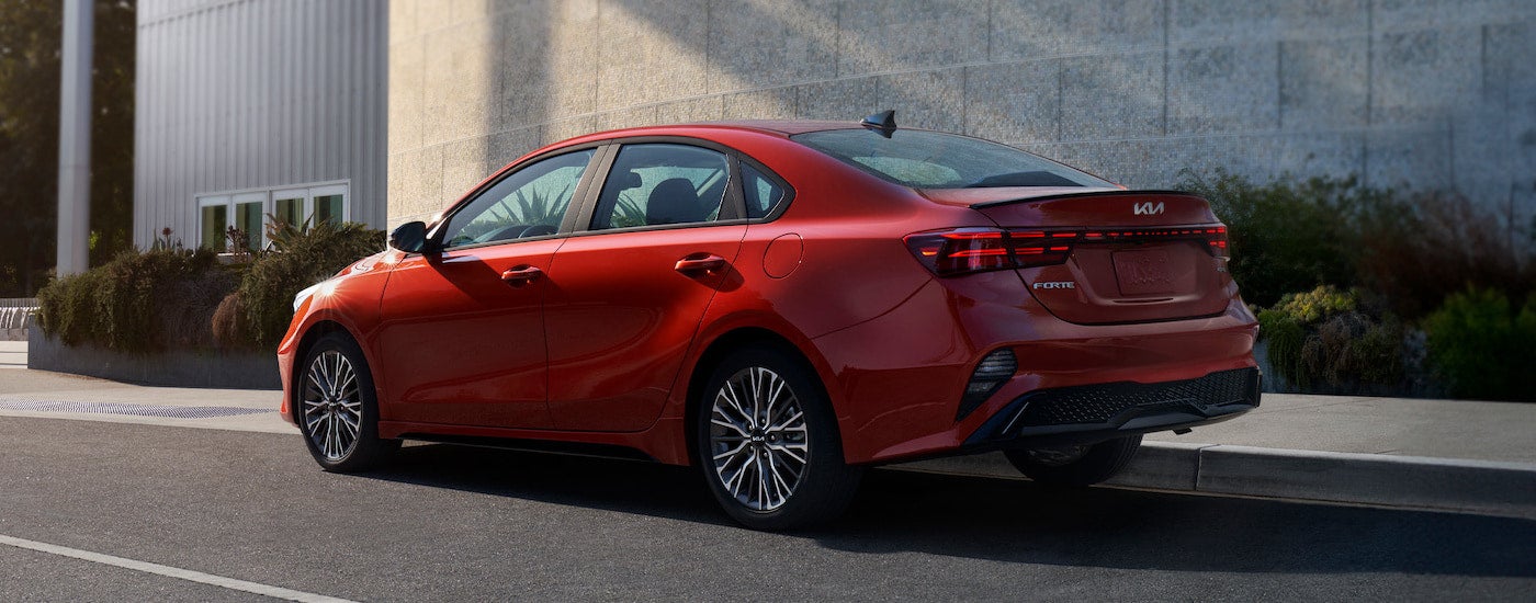 A red 2024 Kia Forte from the rear.