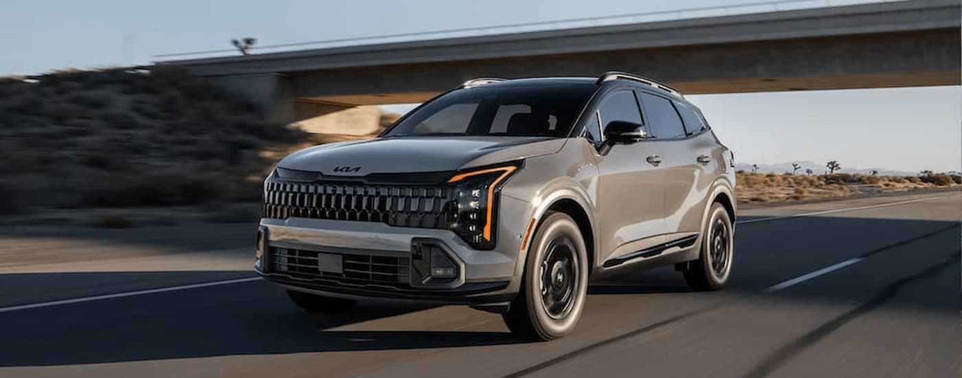 A gray 2026 Kia Sportage driving for sale near Olathe